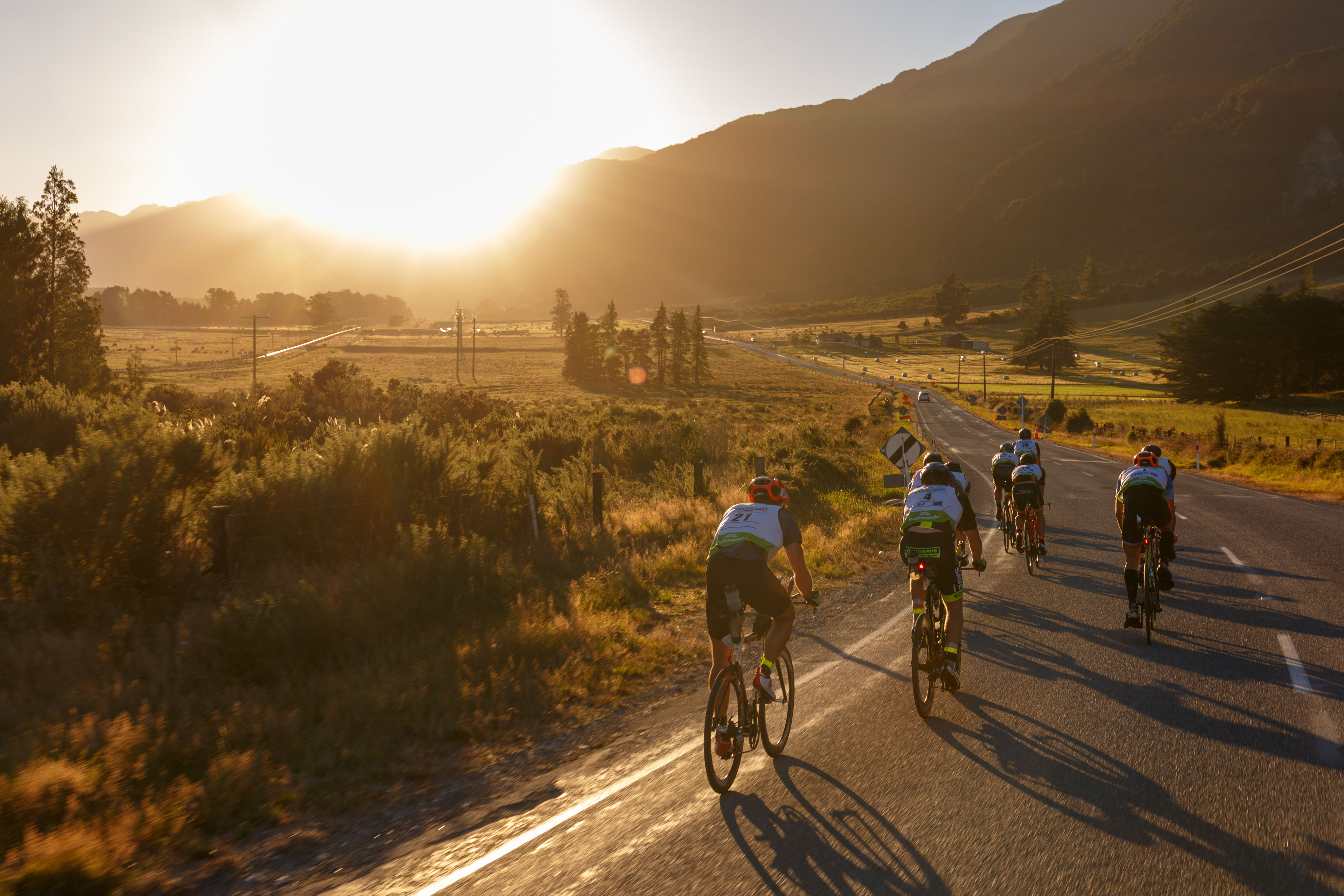 Coast to Coast cycles across beautiful NZ landscapes.