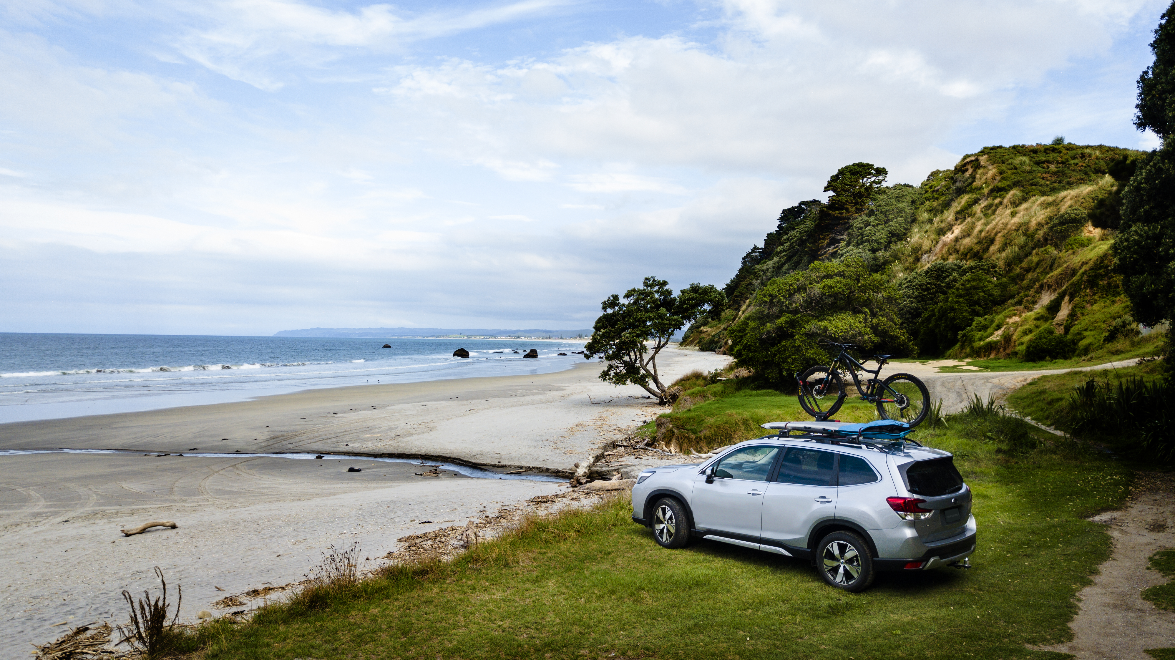 Subaru Forester with bike on roof racks. 