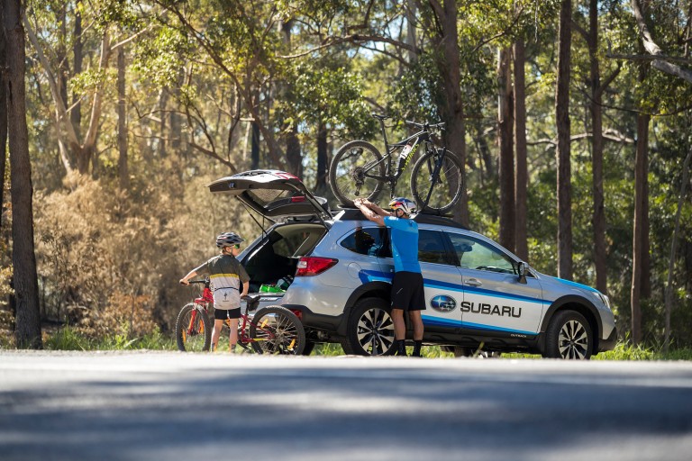 Subaru Brand Ambassador Braden Currie and his son Tarn load a Subaru Outback up with their mountain bikes after a family ride in Noosa, Australia, where Currie was training for the IRONMAN World Championship. PHOTO CREDIT: GRAEME MURRAY, FILTERED VISION.