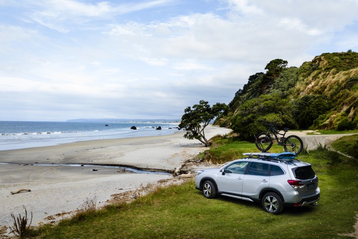 Subaru Forester with bike on roof racks. 