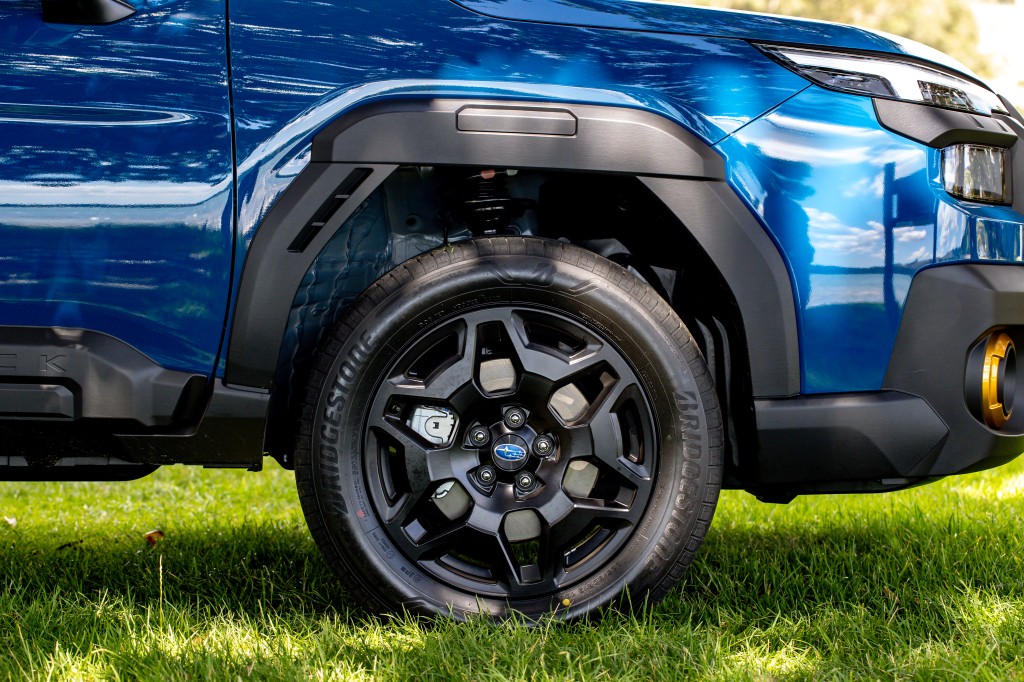 2026 Subaru Outback Wilderness black alloy wheel and all-terrain tire