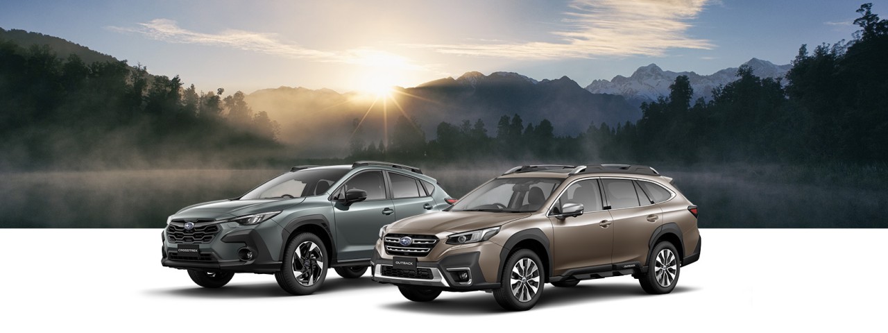 Subaru Outback and Subaru Crosstrek on a landscape background