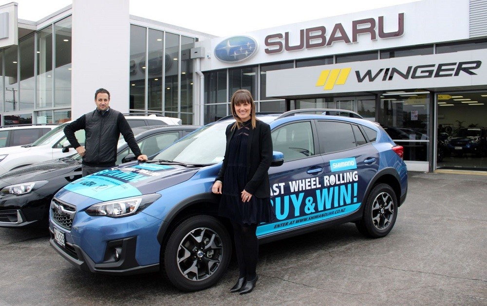 Shimano NZ GM Ben Ashby and Subaru NZ National Marketing Manager Daile Stephens stand with the promo Subaru XV Sport which toured Shimano stockists nationwide as part of the Last Wheel Rolling promotion.