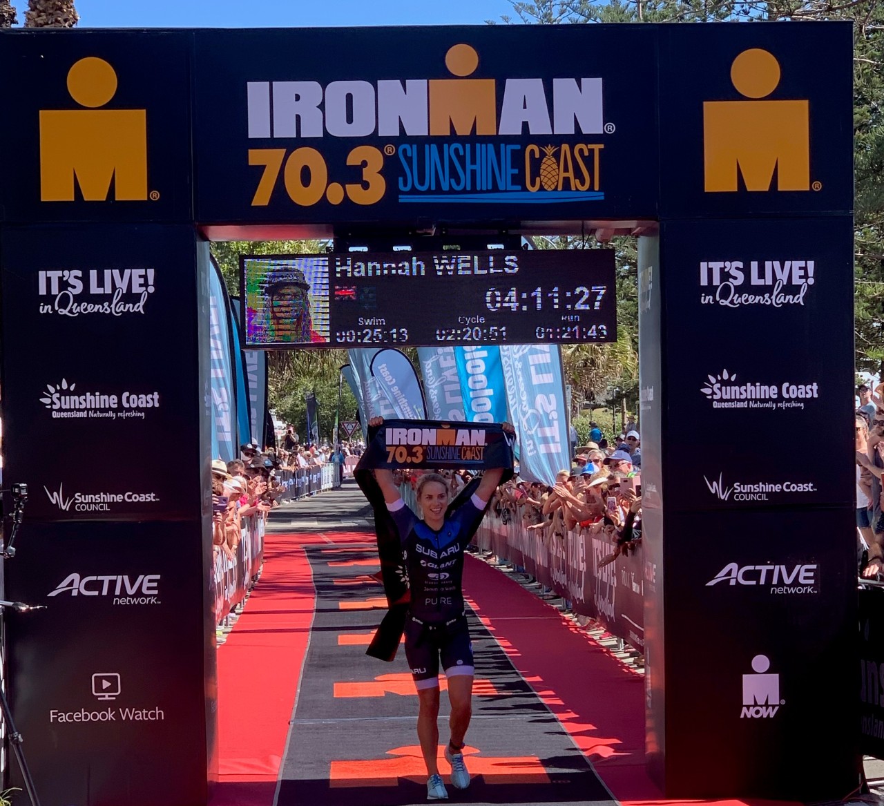 Subaru brand ambassador Hannah Wells crosses the Ironman 70.3 Sunshine Coast finish line in first place  today. PHOTO: NICK BERRY.