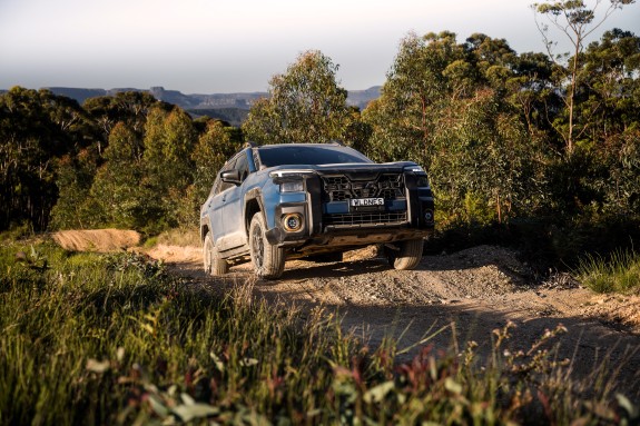 2026 Subaru Outback Wilderness driving up gravel hill